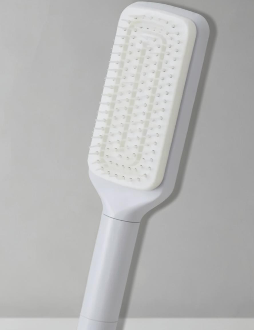 Snaggedly 4-in-1 white self-cleaning hair brush with a rotating head for anti-static detangling and scalp massage.